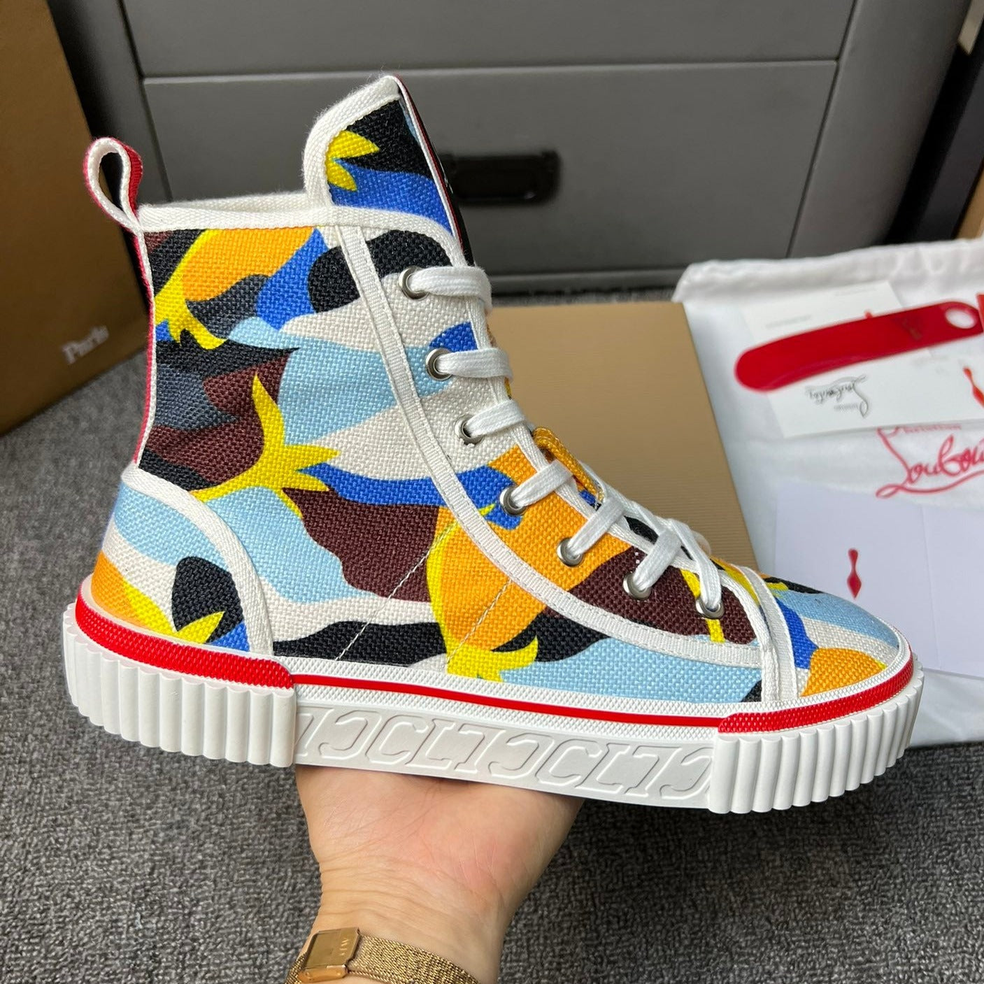 Loubouti'* latest red-soled canvas shoes