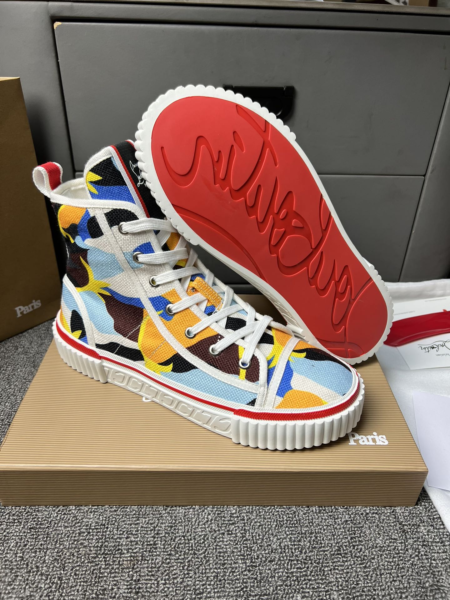 Loubouti'* latest red-soled canvas shoes