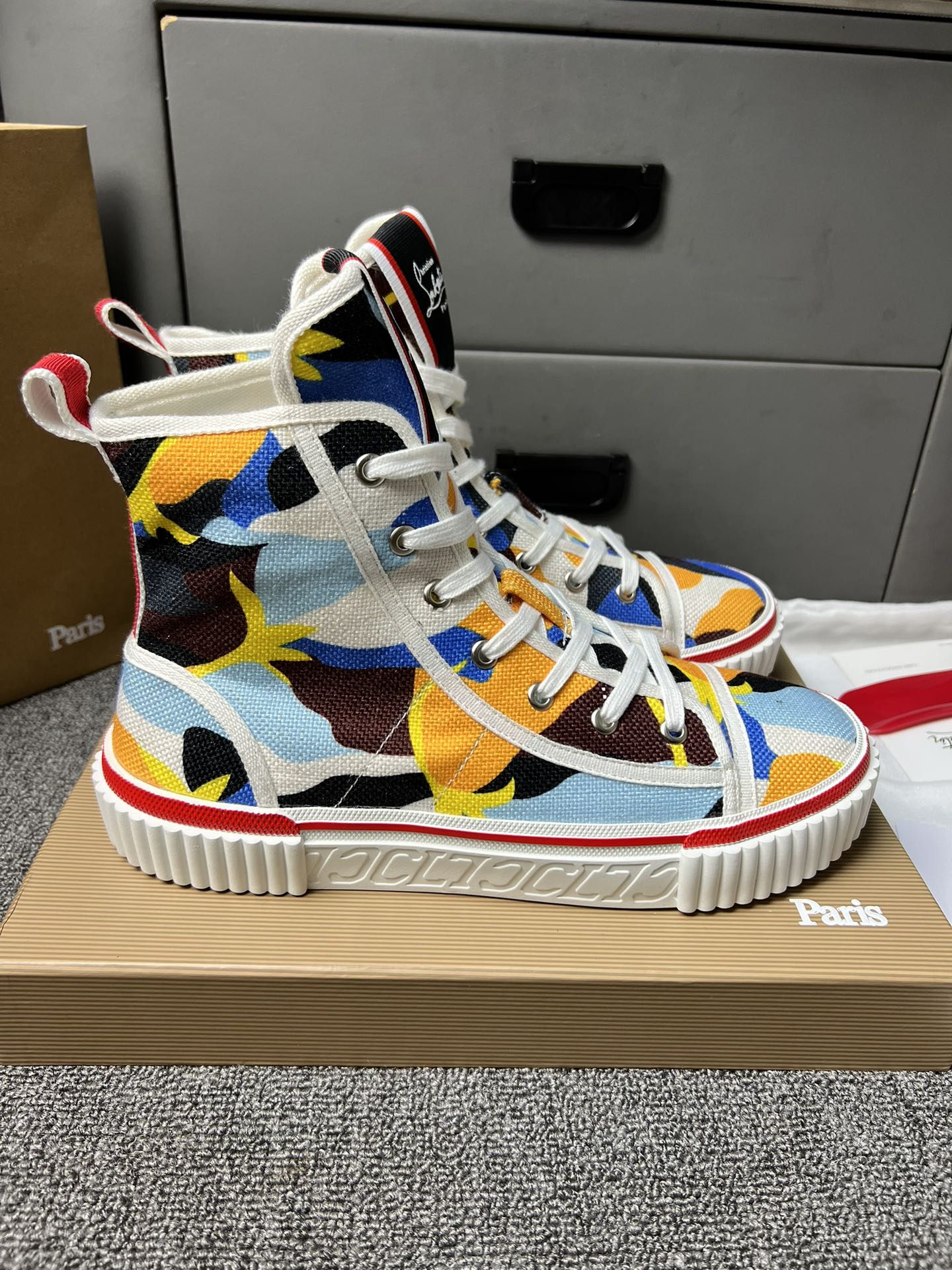 Loubouti'* latest red-soled canvas shoes