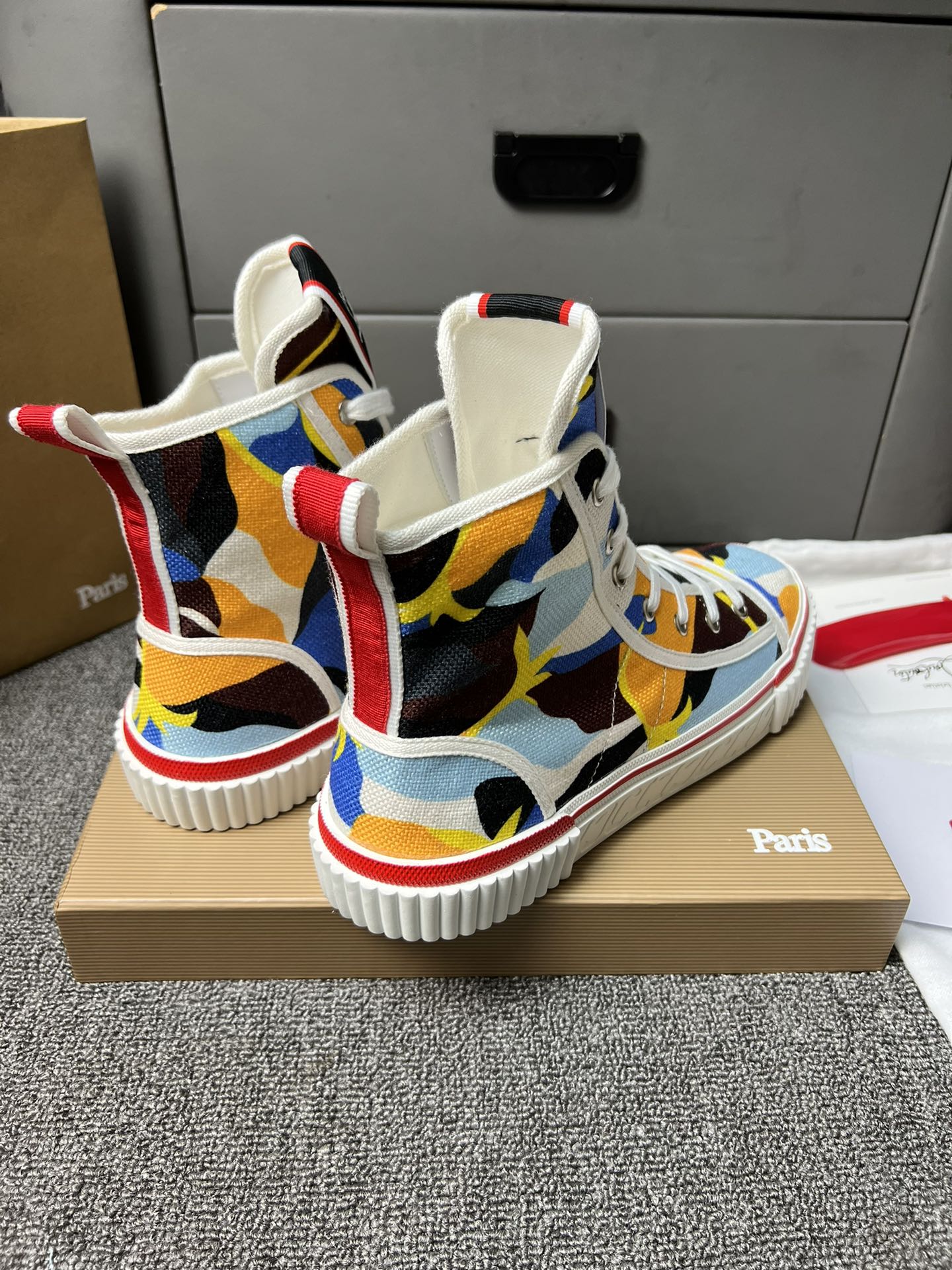 Loubouti'* latest red-soled canvas shoes