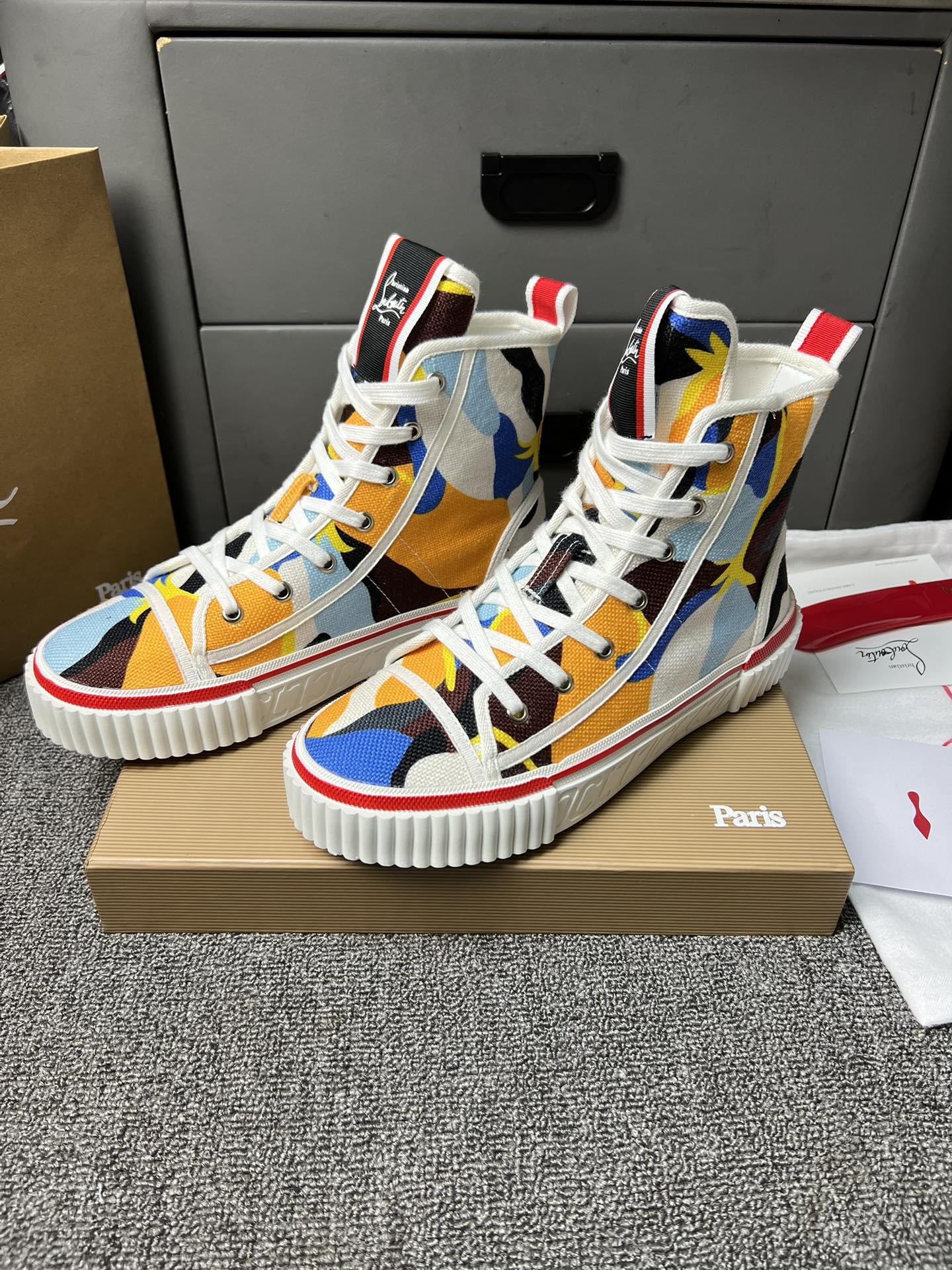 Loubouti'* latest red-soled canvas shoes