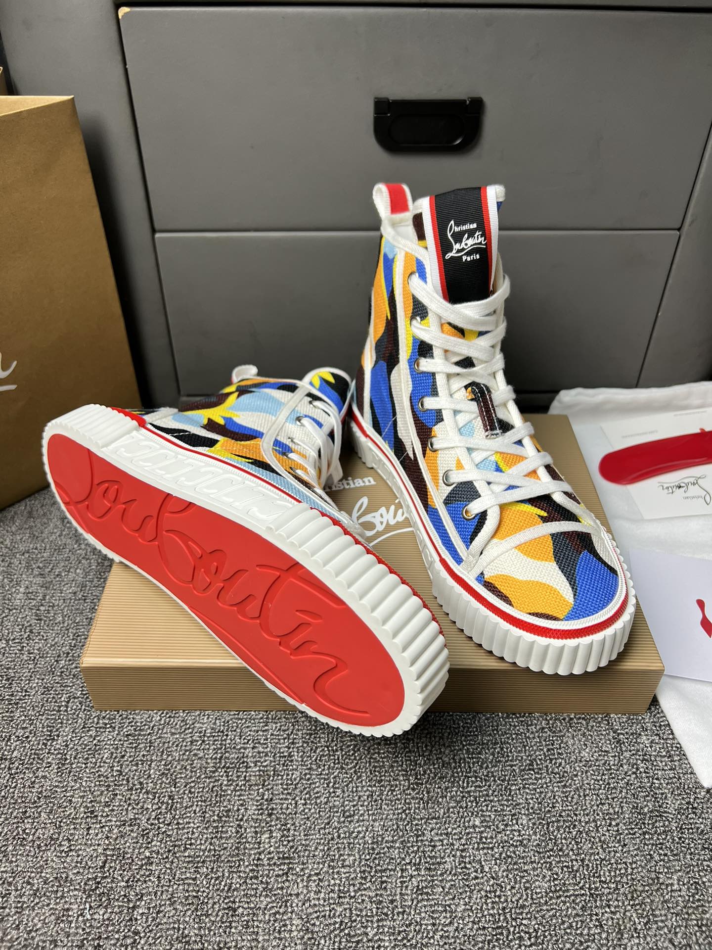 Loubouti'* latest red-soled canvas shoes