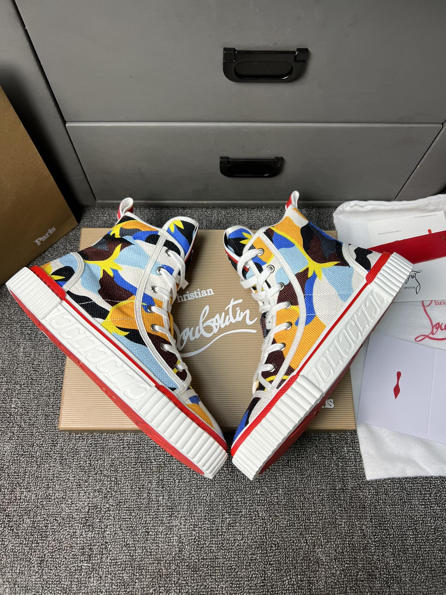 Loubouti'* latest red-soled canvas shoes