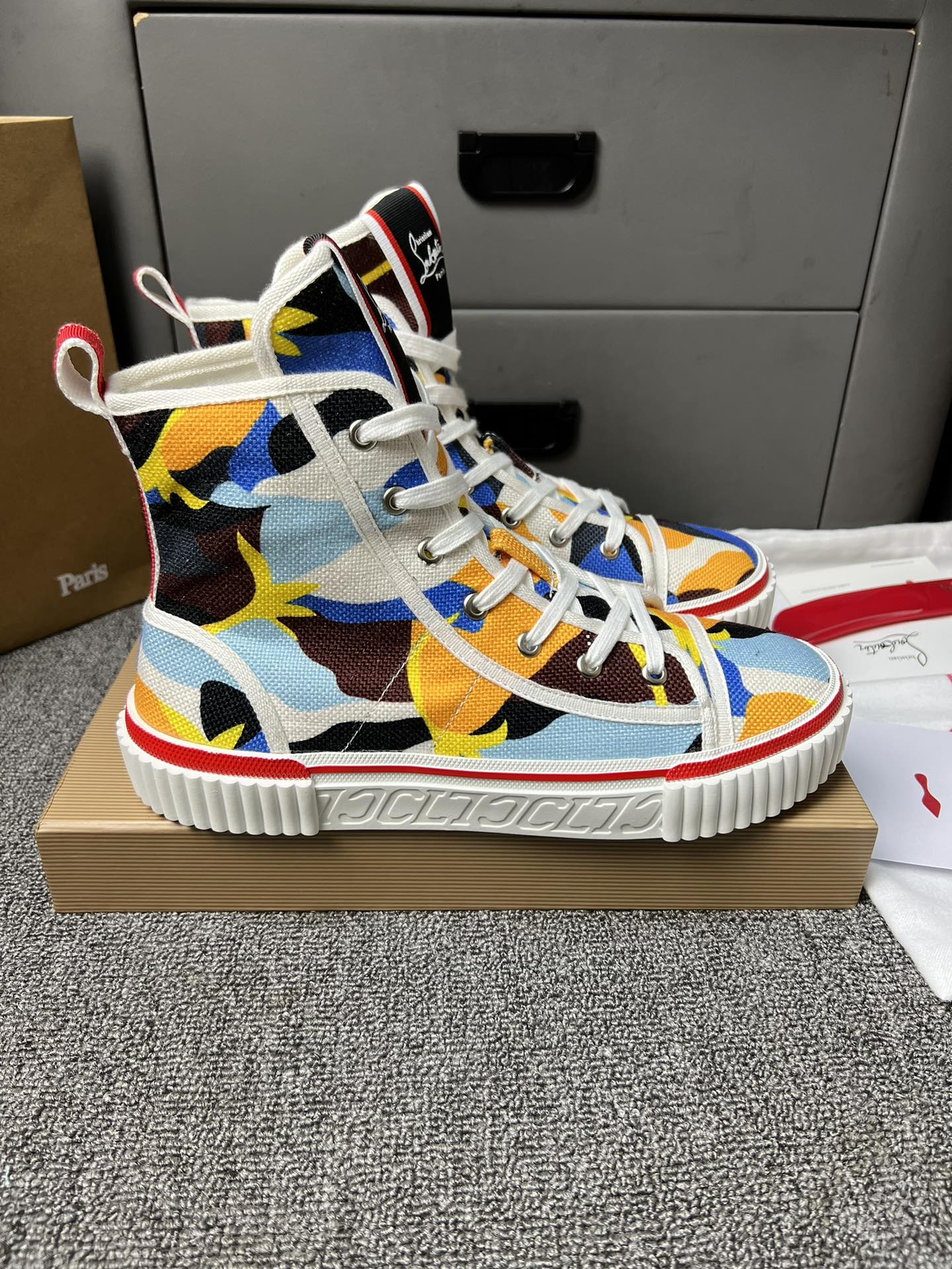 Loubouti'* latest red-soled canvas shoes